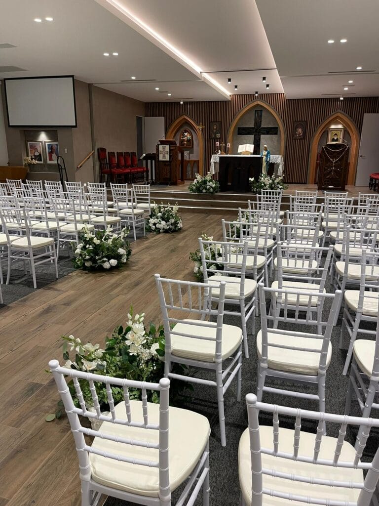 white tiffany chair used for a wedding ceremony in a chapel